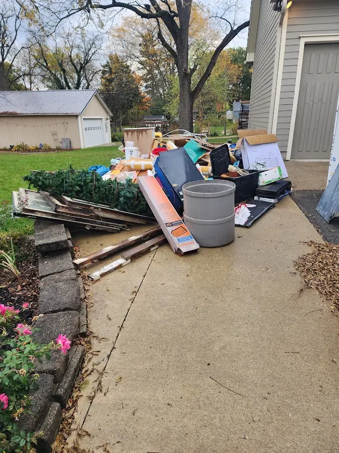 Dumpster being loaded with debris for 10 Yard Dumpster Rental in Iroquois Point